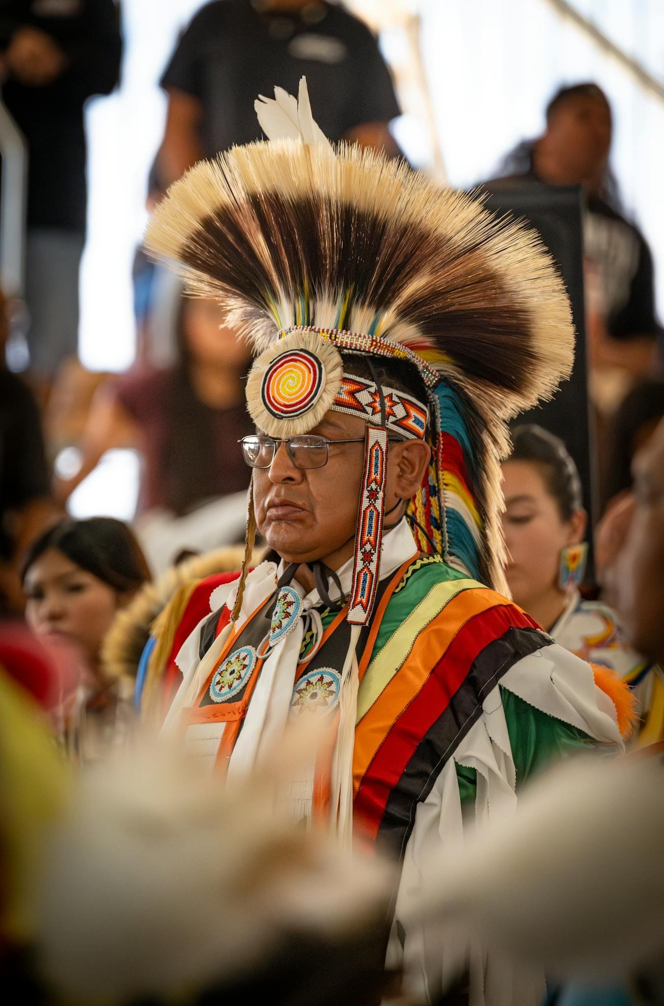 Man in colorful traditional Native American attire at a cultural festival, Morongo Valley, CA.